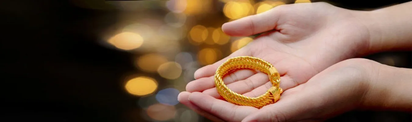 Gold bangle held in open hands for gold loans
